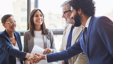 Group of professionals shaking hands