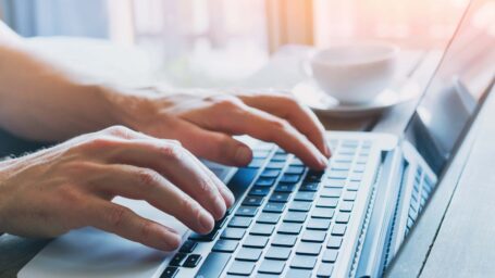 close up of hands of business person working on computer, man using internet and social media