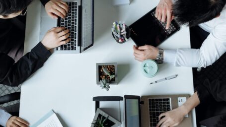 a group of people working on laptops