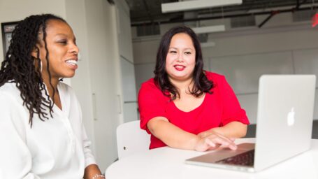 Woman Wearing Red Top Holding Silver Macbook