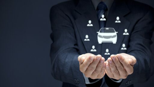 Persons hands pretending to hold a hologram of a car
