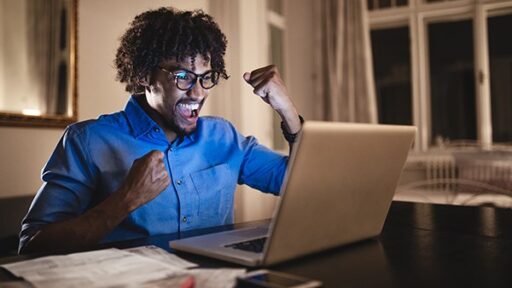 Person at a desk looking at a laptop
