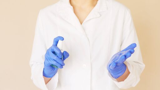 Person wearing gloves and a lab coat